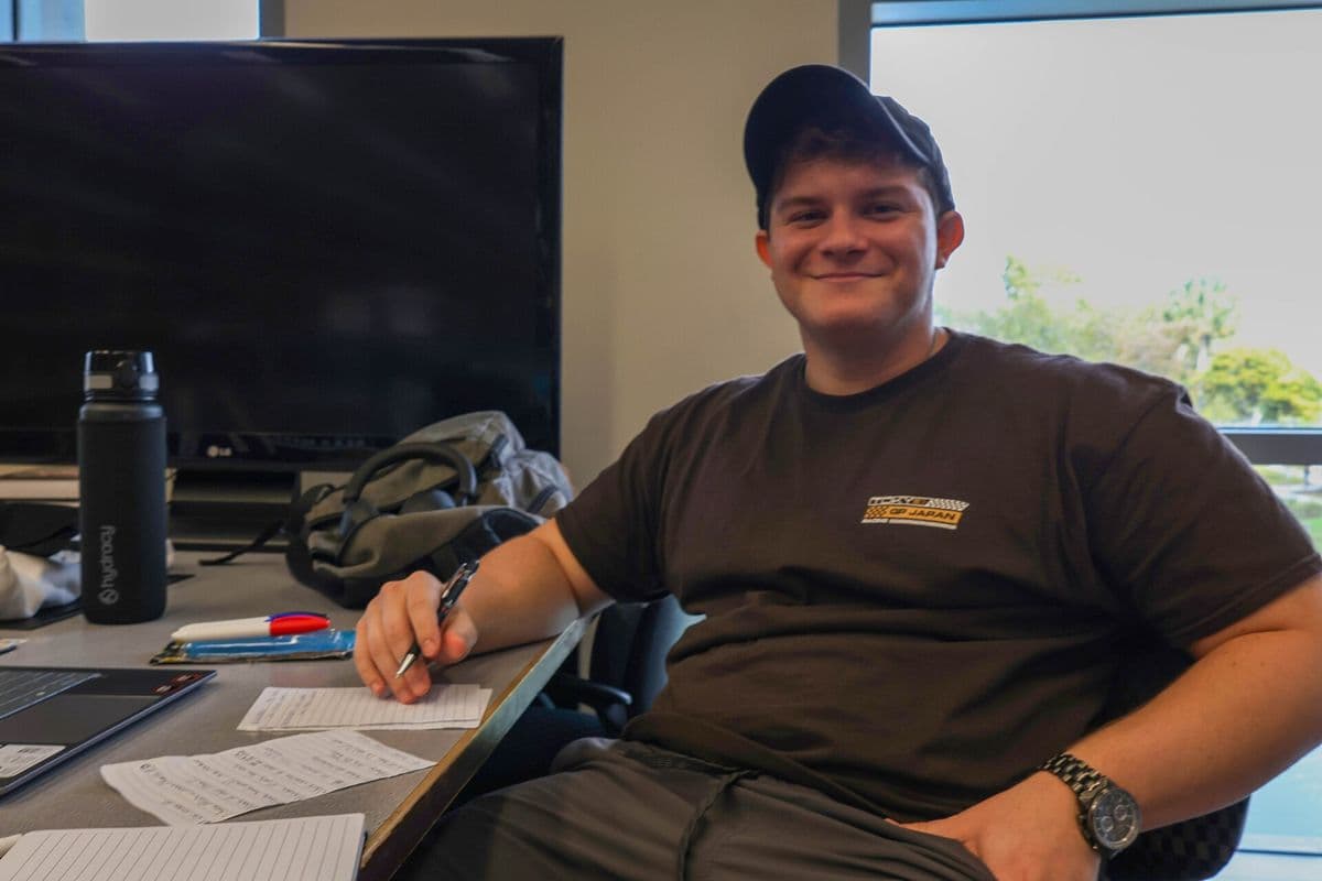 A worker at a desk with a notebook.