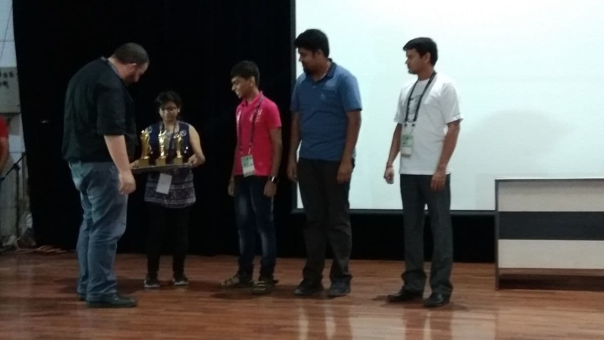 People standing on a stage in front of an audience.