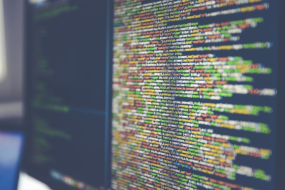 Lines of colourful programming code on a dark screen.