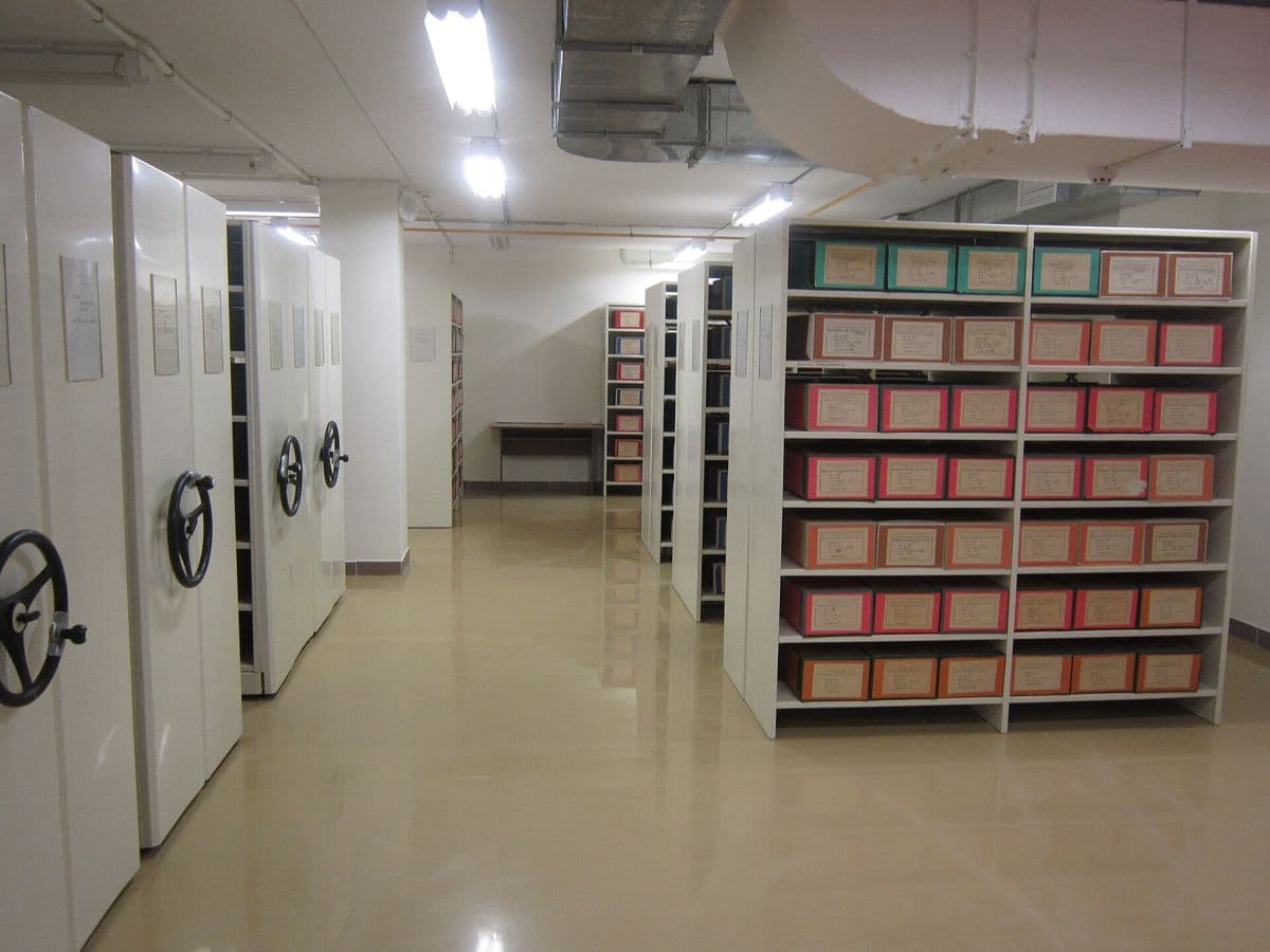 Rows of archive shelving in a storage room.